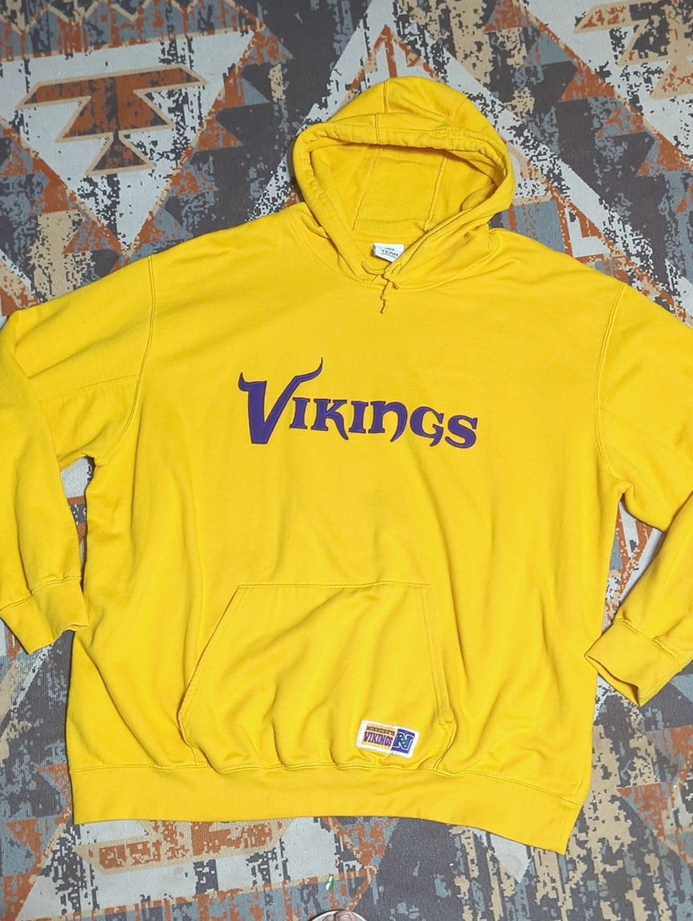 Minnesota Vikings hooded sweatshirt with purple "Vikings" lettering on the chest